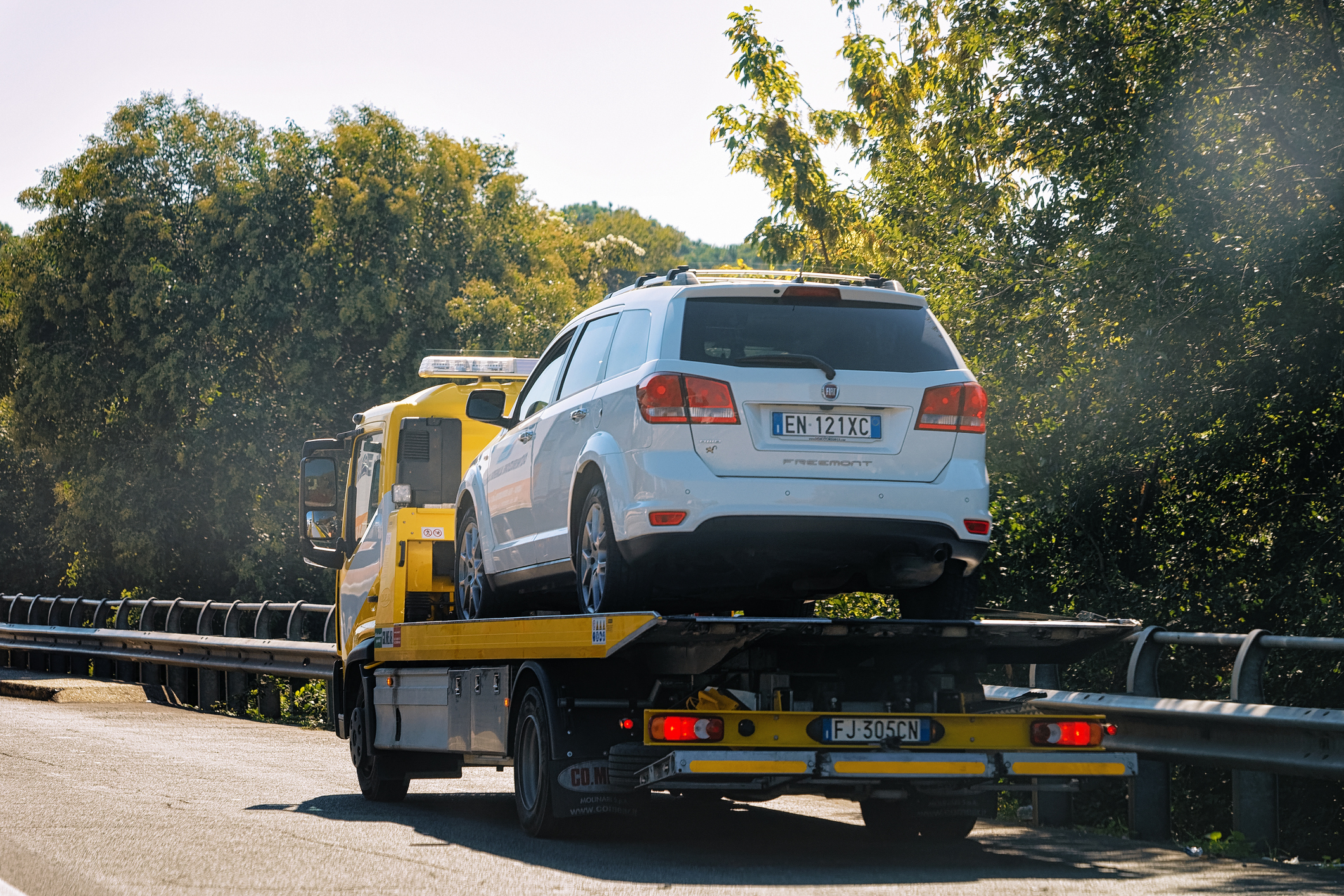 Tow truck with a car on the road